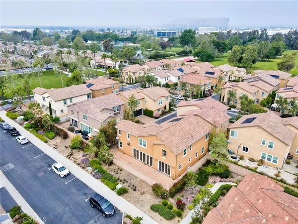 an aerial view of a house with a garden and lake view