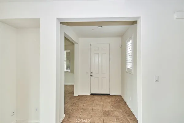 a view of a hallway with closet and bathroom
