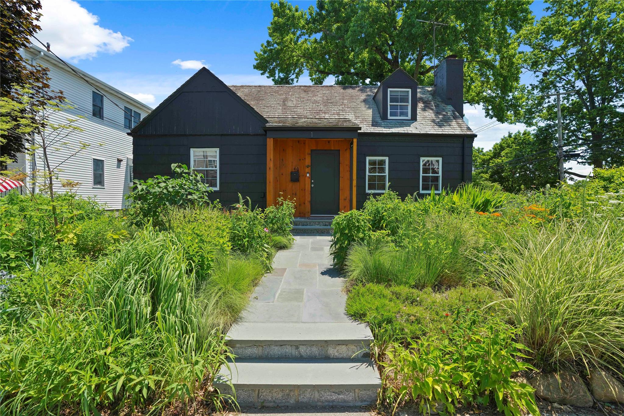 a front view of a house with garden