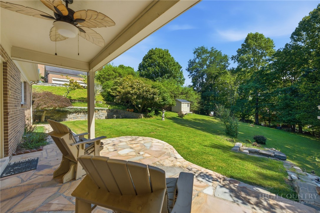 304 Glendale Drive Boone, NC 28607 - Photo 22 of 50 a view of a patio with a table chairs and a yard