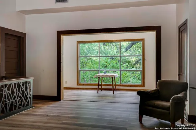 a view of a room with workspace window and wooden floor