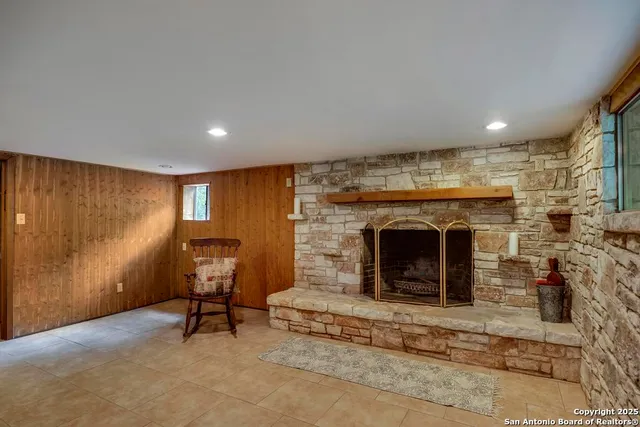 a view of a livingroom with a chair and a fireplace