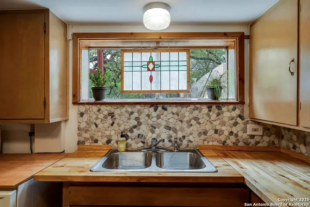 a view of a backyard with large trees