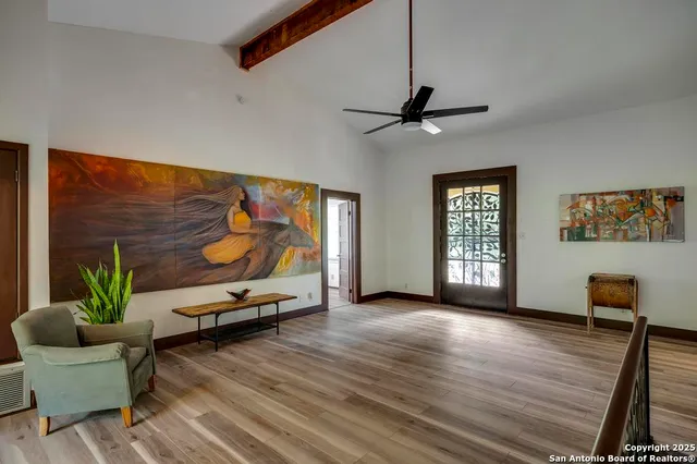 a living room with furniture and wooden floor