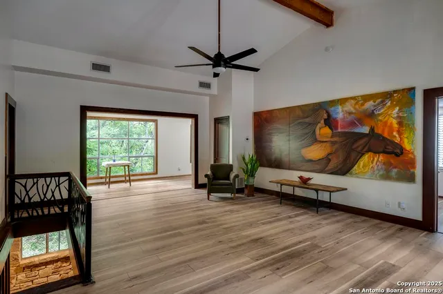 a view of a livingroom with furniture window and wooden floor