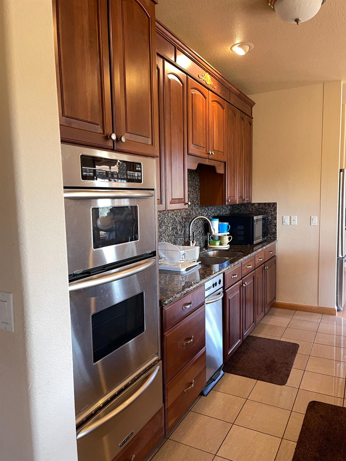 717 Swanson Lane Colfax, CA 95713 - Photo 8 of 44 a kitchen with stainless steel appliances granite countertop a stove microwave and cabinets