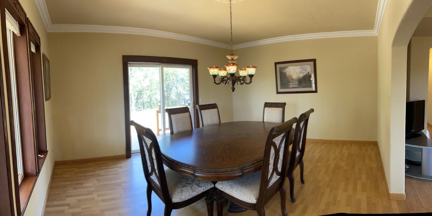 717 Swanson Lane Colfax, CA 95713 - Photo 10 of 44 a view of a dining room with furniture and chandelier