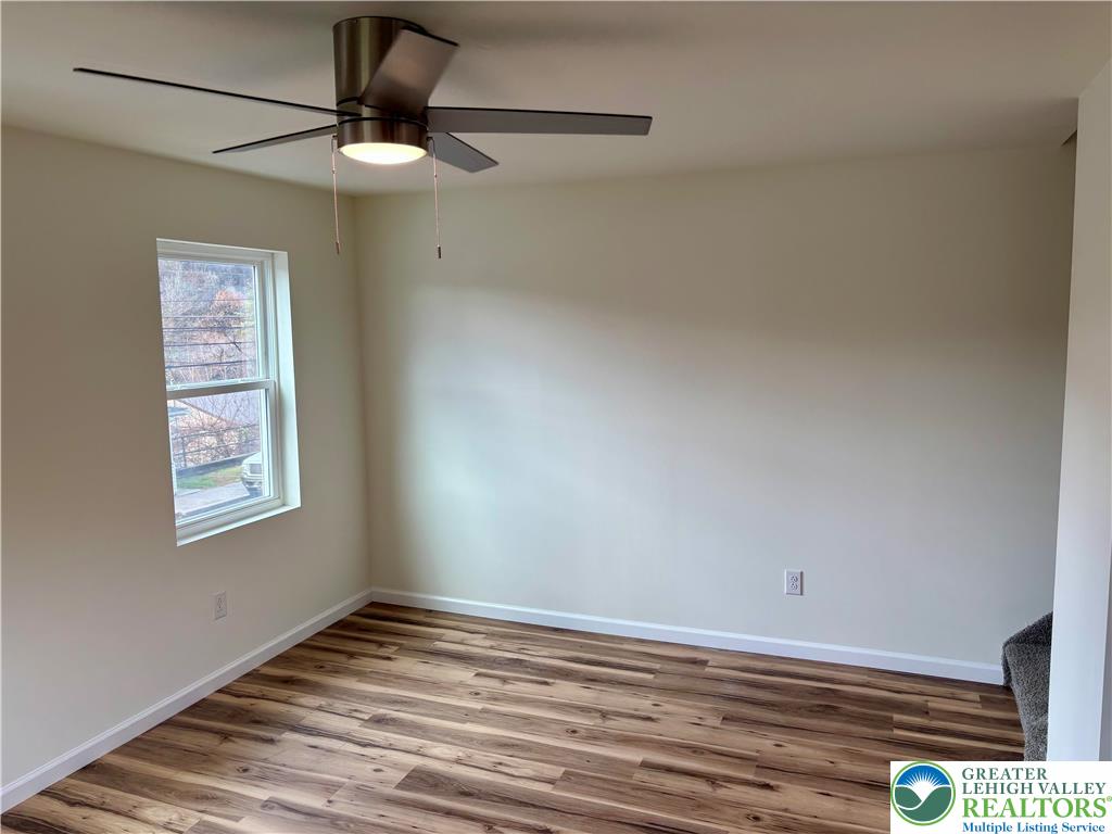 253 Main Street Parryville, PA 18071 - Photo 11 of 31 a view of an empty room with window and wooden floor