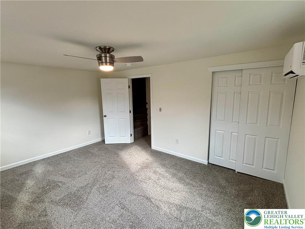 253 Main Street Parryville, PA 18071 - Photo 16 of 31 an empty room with a chandelier fan and windows