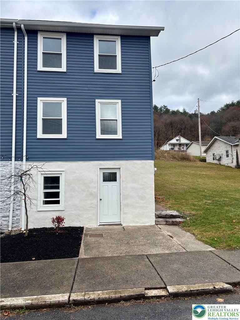 253 Main Street Parryville, PA 18071 - Photo 3 of 31 a brick house with a yard