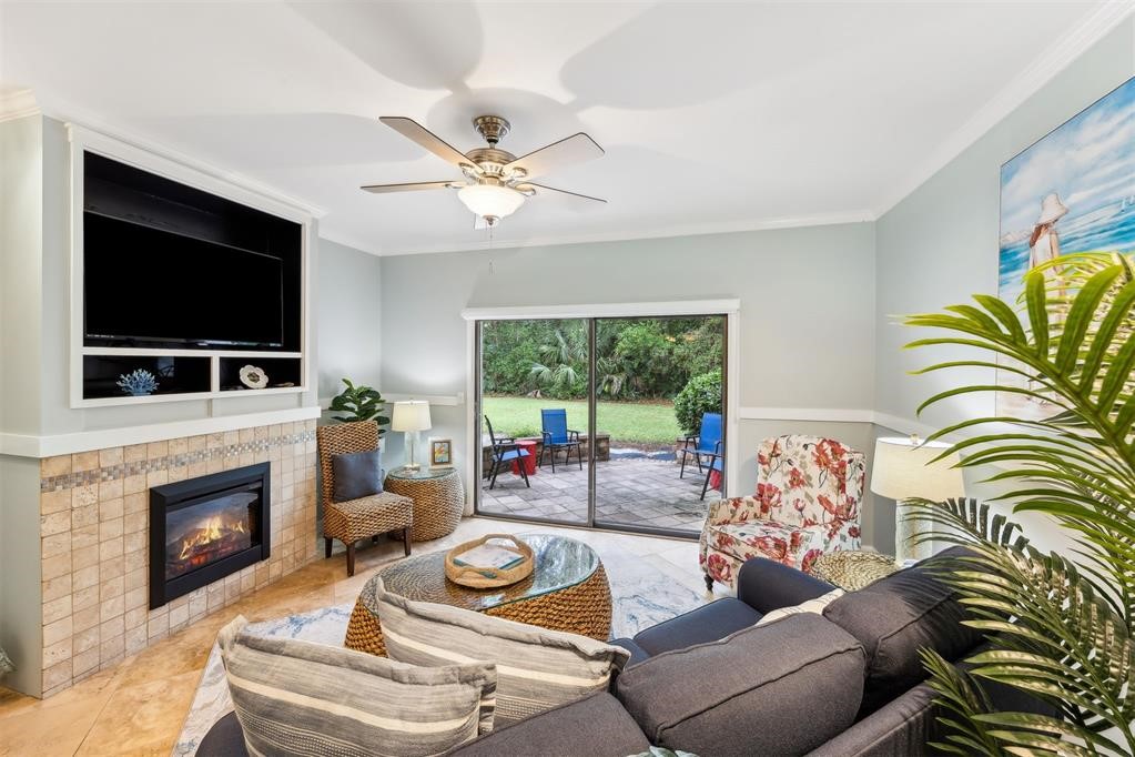3033 Sea Marsh Road Fernandina Beach, FL 32034 - Photo 7 of 37 a living room with furniture a flat screen tv and a fireplace