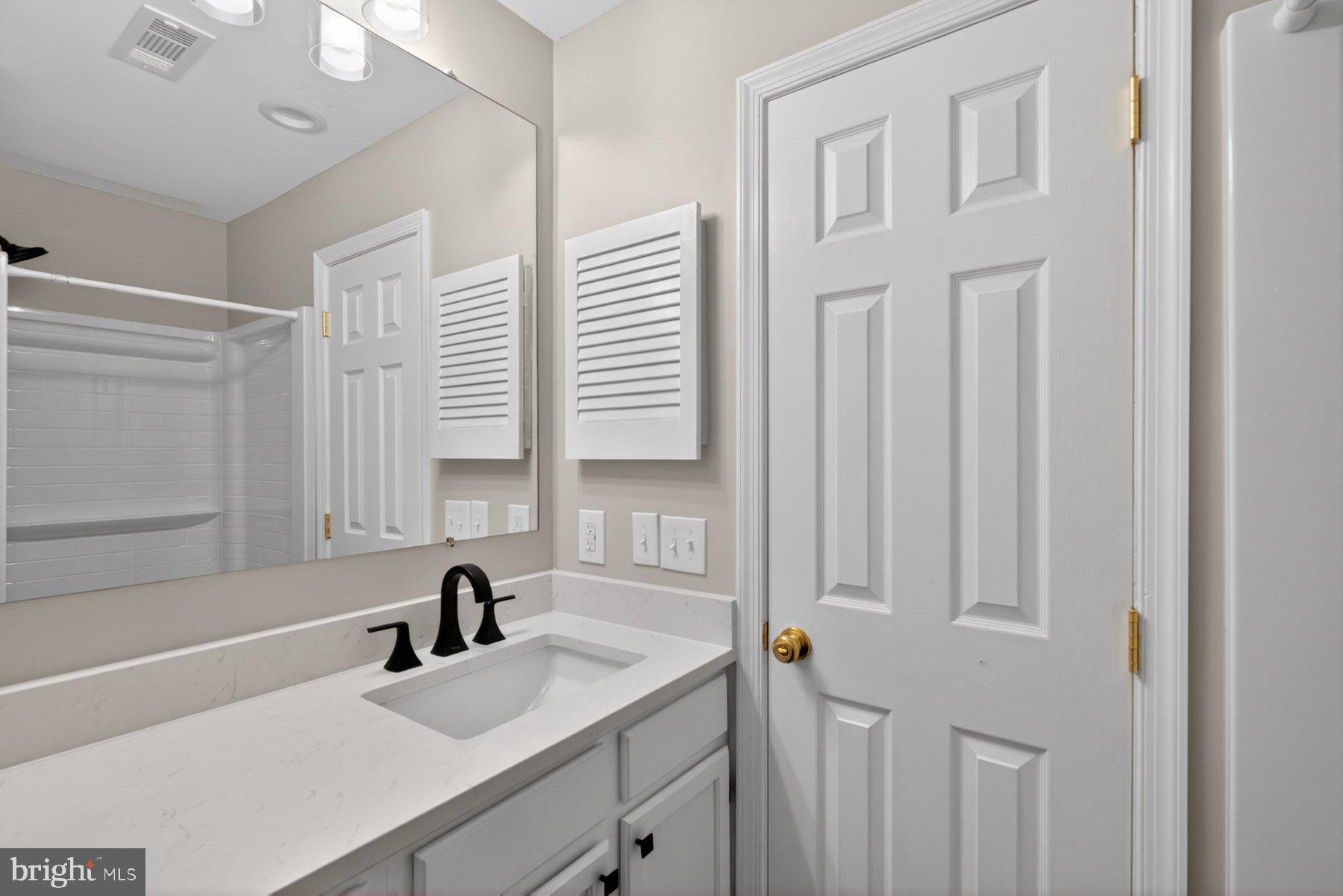 365 Pleasanton Road, Unit A13 Westminster, MD 21157 - Photo 13 of 25 a bathroom with a sink and a mirror