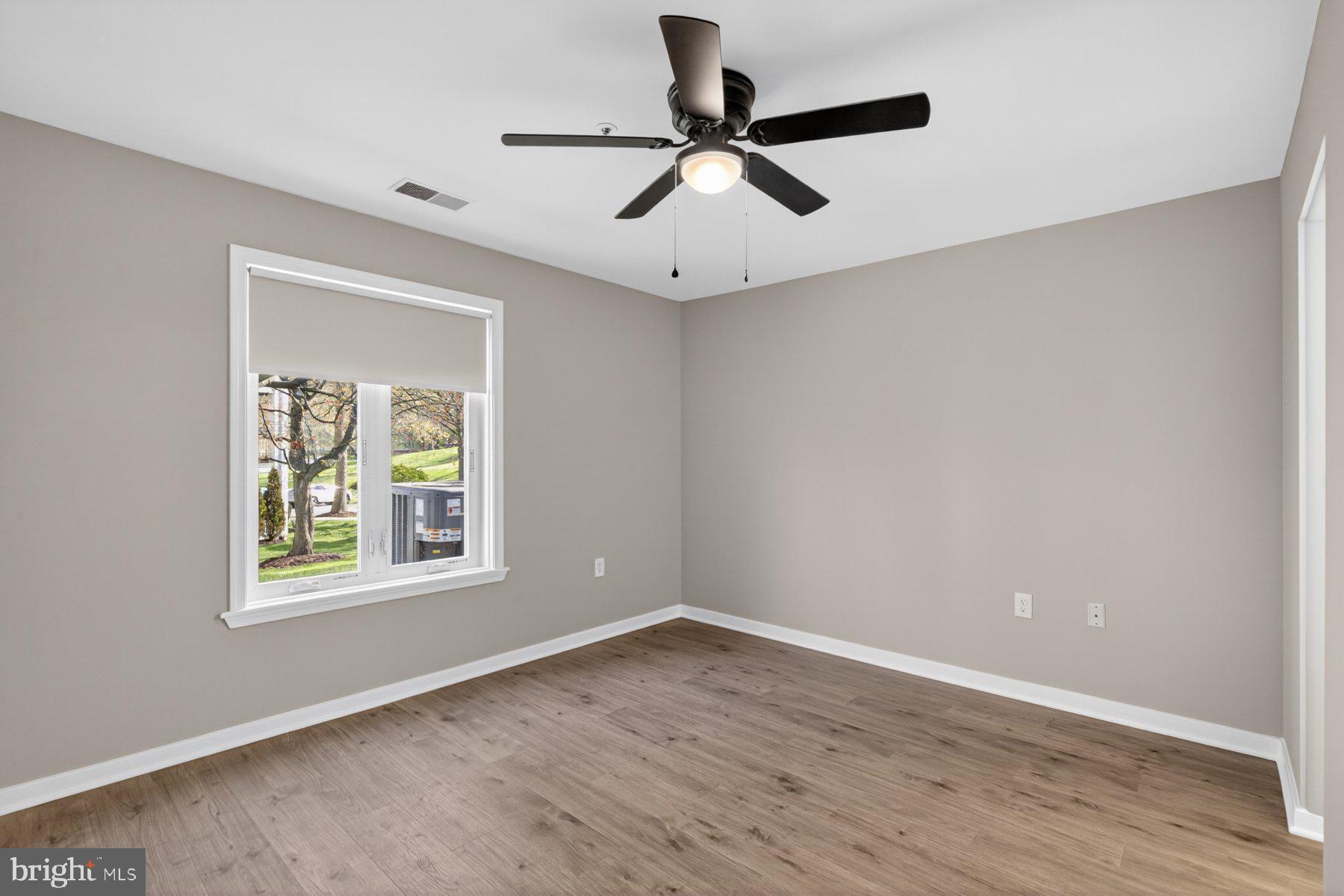 365 Pleasanton Road, Unit A13 Westminster, MD 21157 - Photo 16 of 25 a view of an empty room with a window and wooden floor