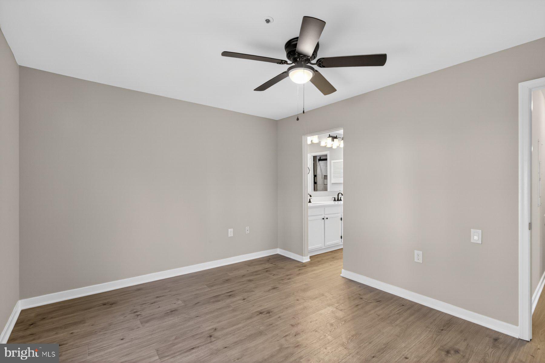 365 Pleasanton Road, Unit A13 Westminster, MD 21157 - Photo 17 of 25 a view of a room with a ceiling fan and wooden floor