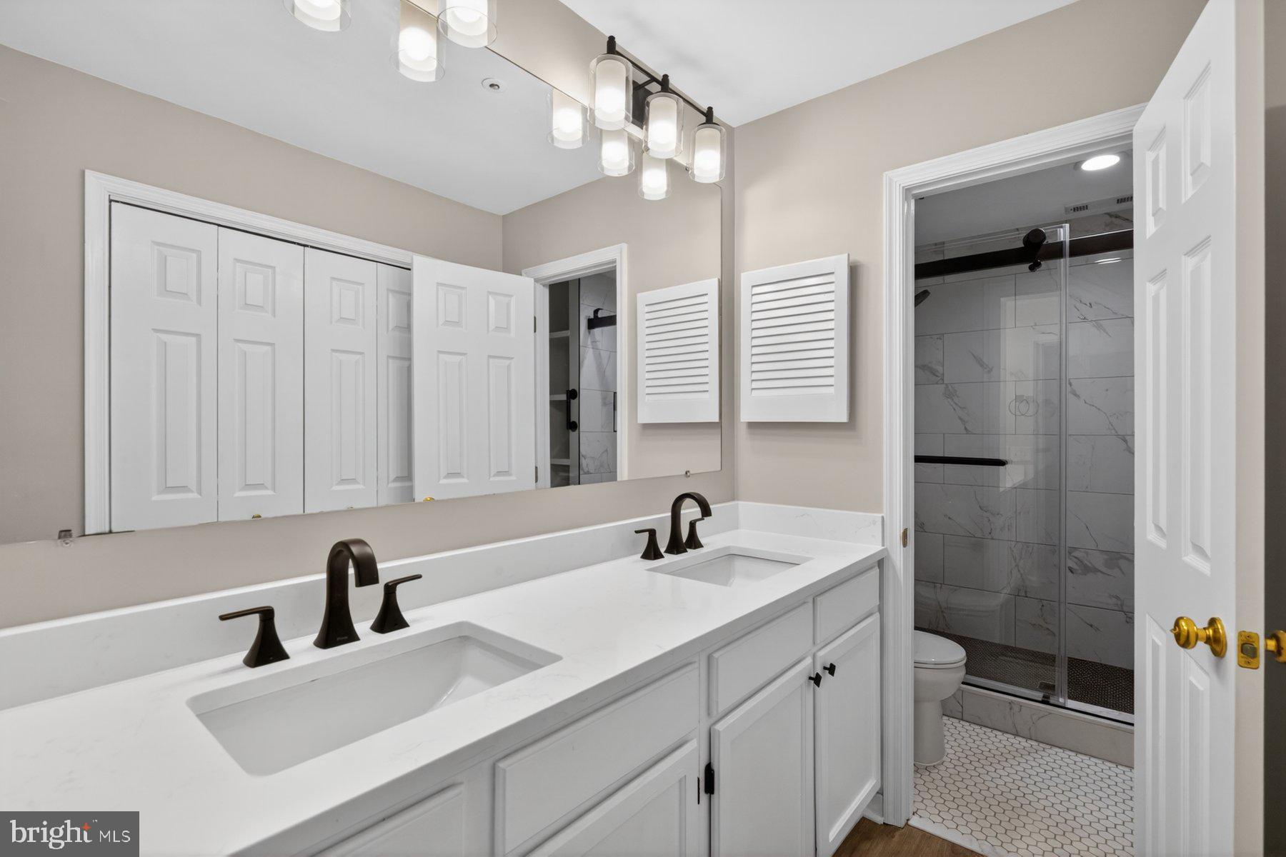 365 Pleasanton Road, Unit A13 Westminster, MD 21157 - Photo 19 of 25 a bathroom with a sink double vanity and a shower