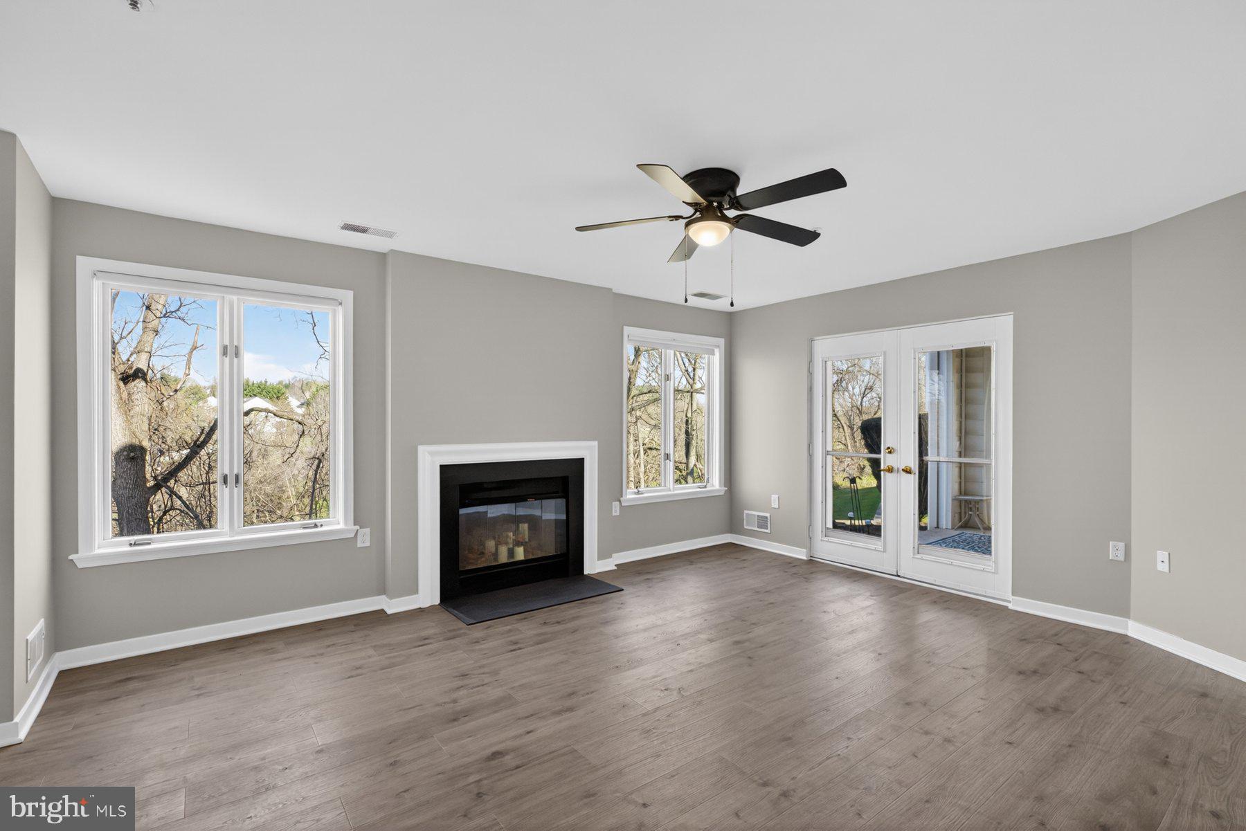 365 Pleasanton Road, Unit A13 Westminster, MD 21157 - Photo 2 of 25 a view of a livingroom with a fireplace a ceiling fan and wooden floor