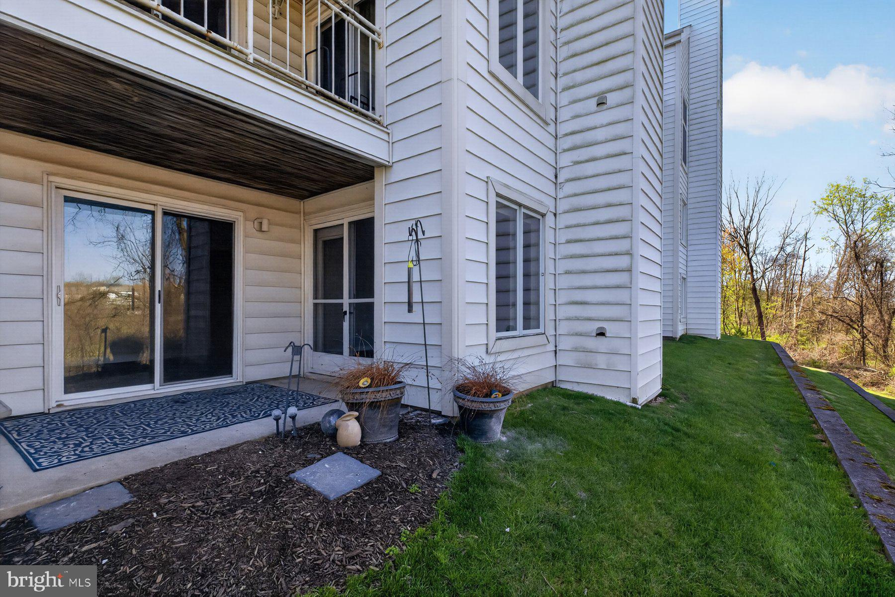365 Pleasanton Road, Unit A13 Westminster, MD 21157 - Photo 22 of 25 a view of a backyard with plants and outdoor seating