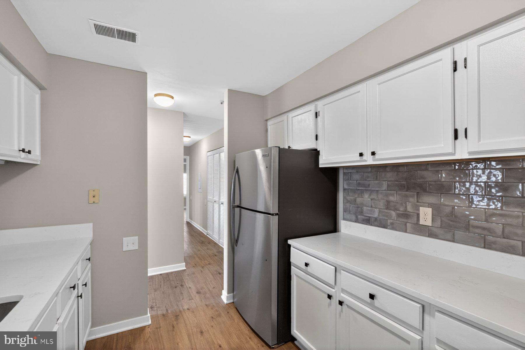 365 Pleasanton Road, Unit A13 Westminster, MD 21157 - Photo 10 of 25 a kitchen with a refrigerator and a stove