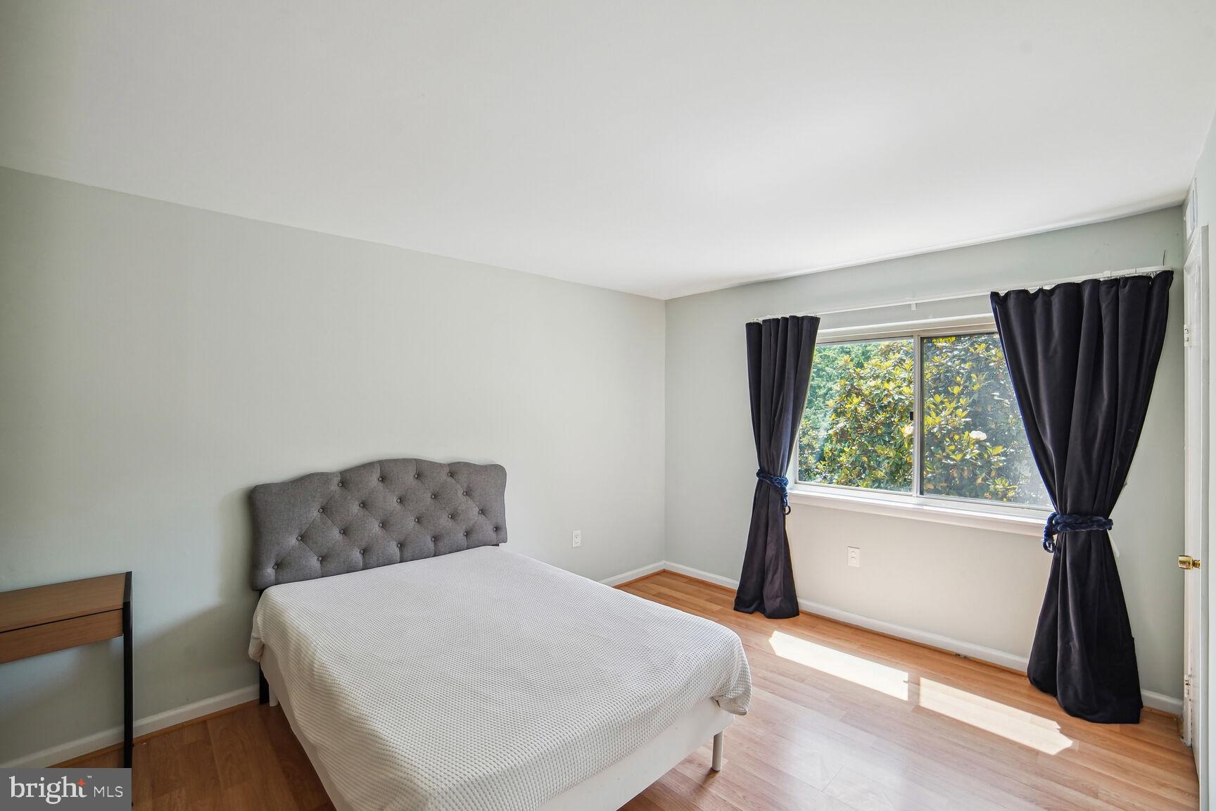 12200 Braxfield Court, Unit 209 Rockville, MD 20852 - Photo 11 of 17 a bedroom with a bed and a window