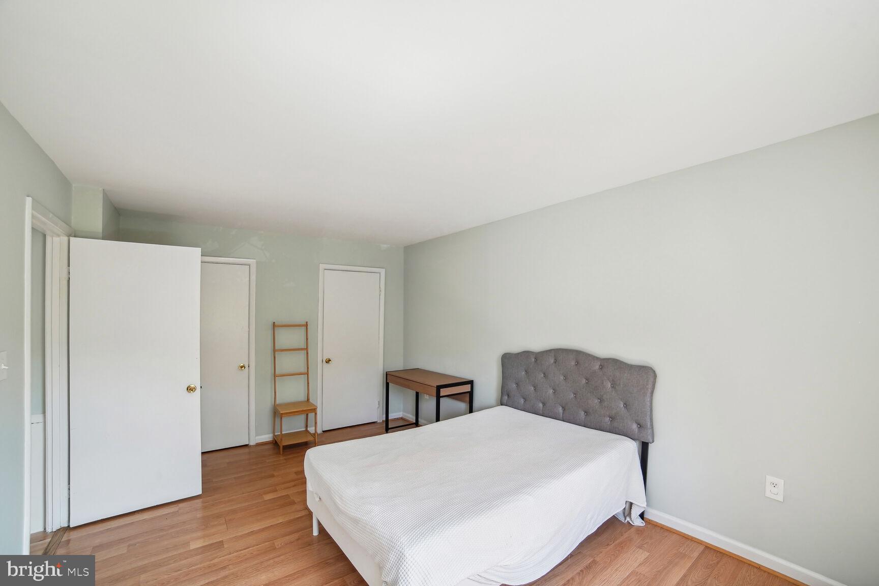 12200 Braxfield Court, Unit 209 Rockville, MD 20852 - Photo 12 of 17 a living room with furniture and wooden floor