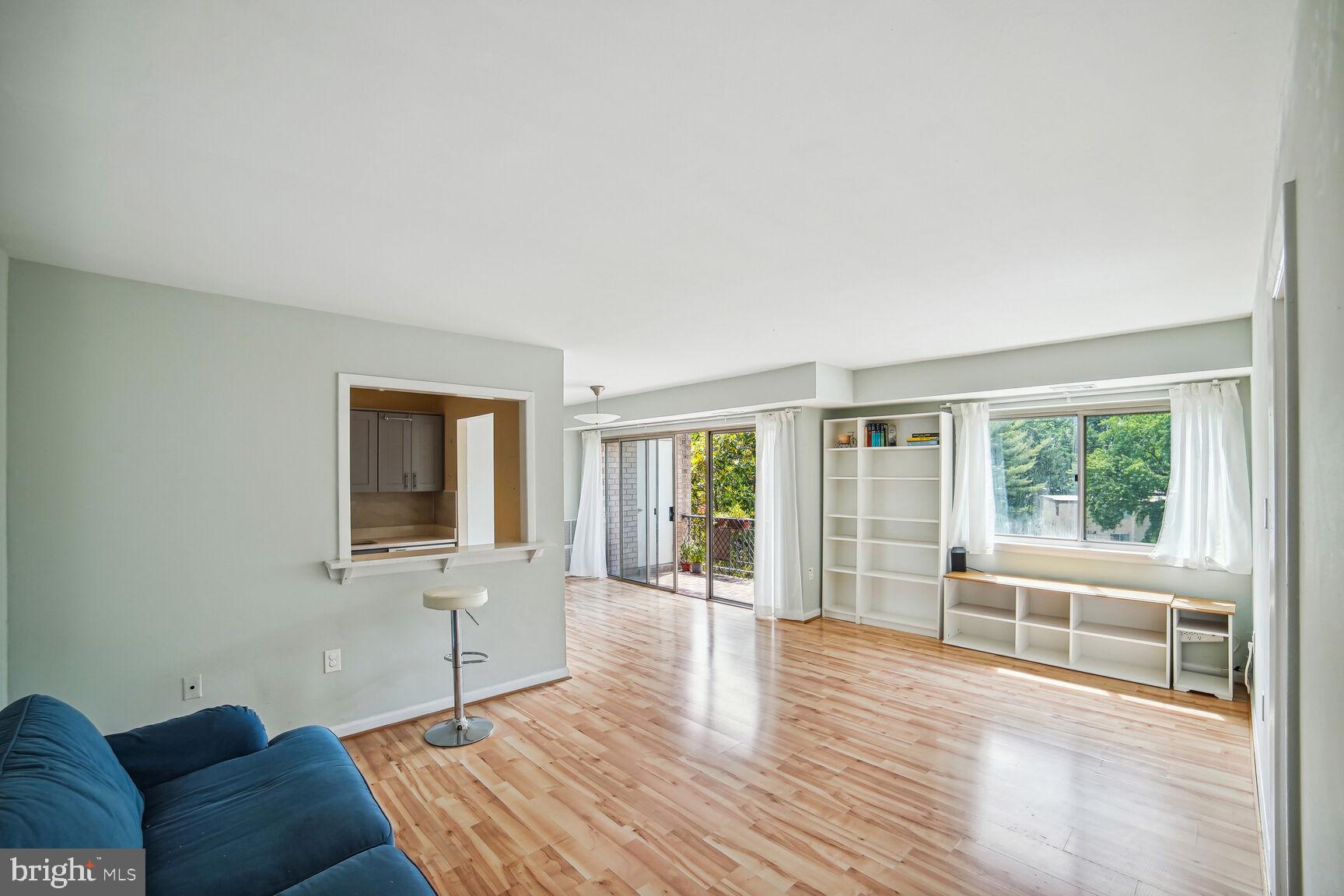 12200 Braxfield Court, Unit 209 Rockville, MD 20852 - Photo 2 of 17 a living room with furniture and a flat screen tv