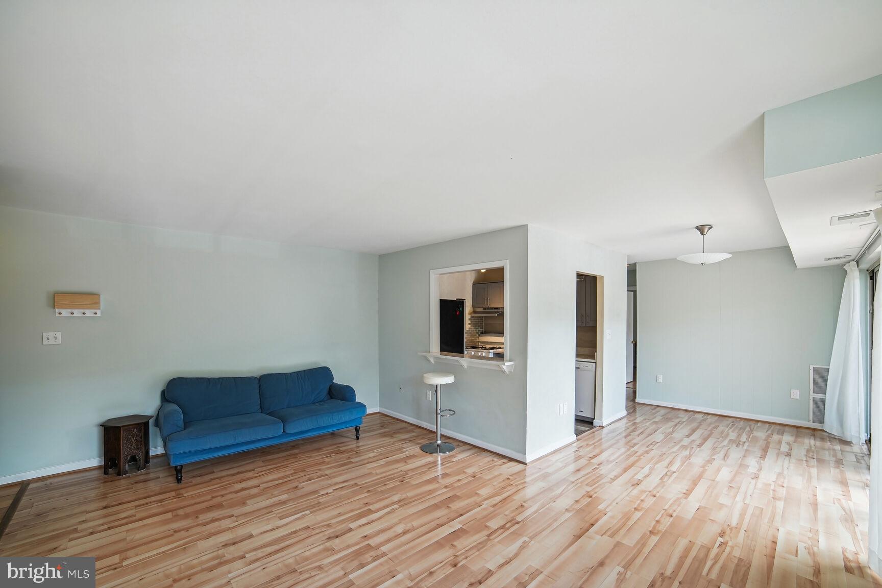 12200 Braxfield Court, Unit 209 Rockville, MD 20852 - Photo 3 of 17 a view of livingroom with furniture and wooden floor