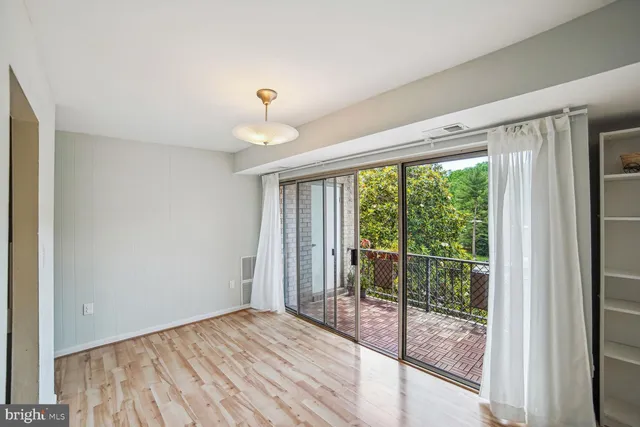 a view of a room with wooden floor and balcony