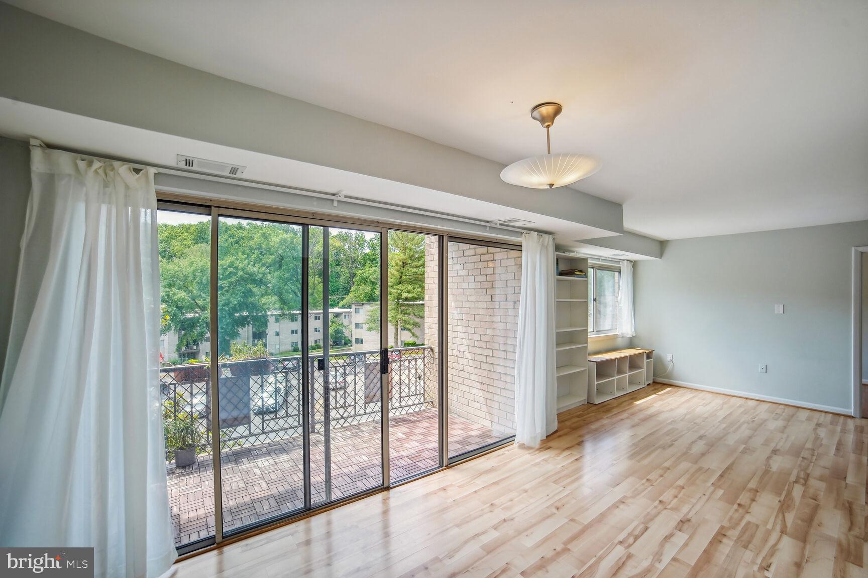 12200 Braxfield Court, Unit 209 Rockville, MD 20852 - Photo 5 of 17 a view of empty room with wooden floor and fan