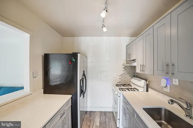 a kitchen that has a microwave a stove and a refrigerator