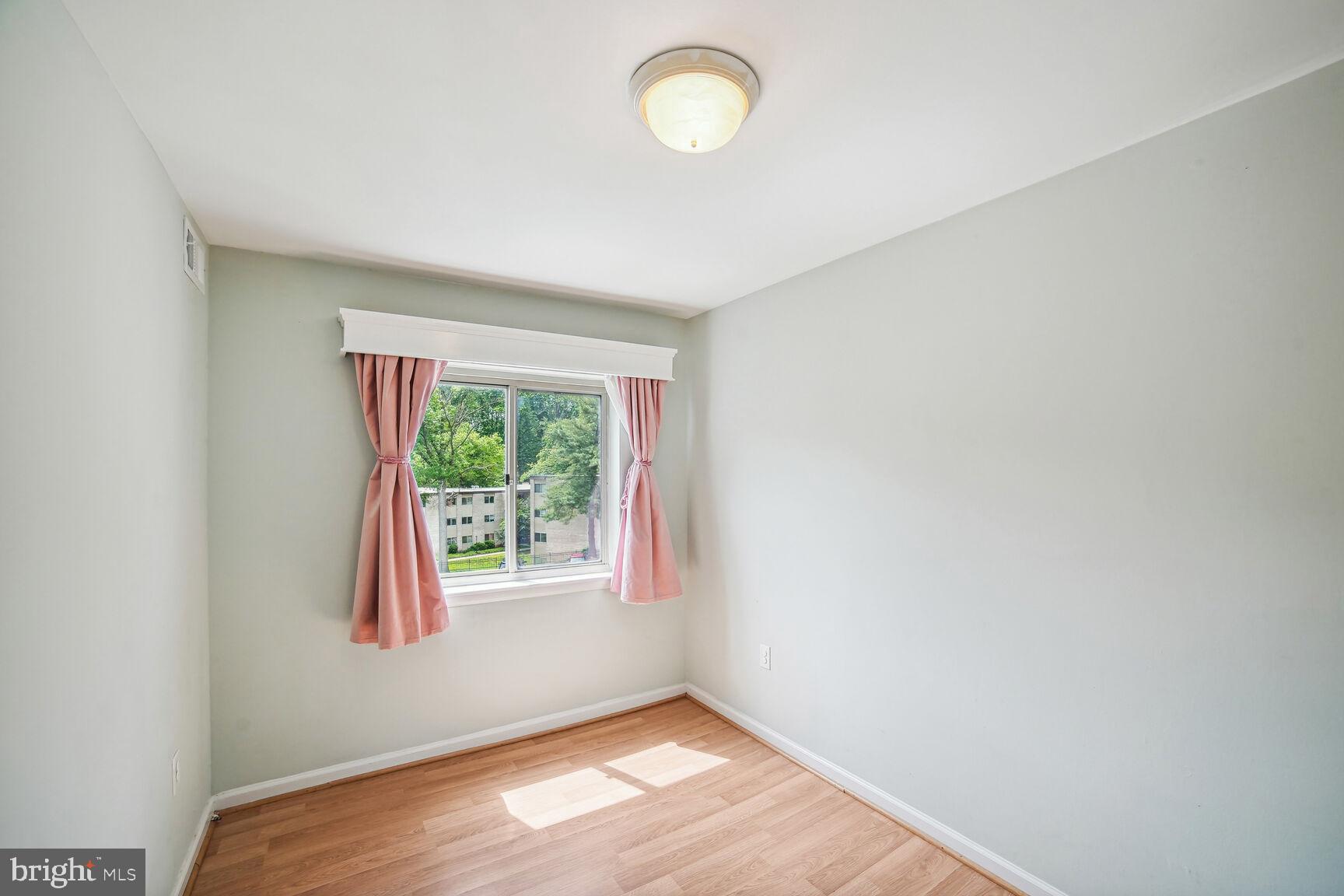 12200 Braxfield Court, Unit 209 Rockville, MD 20852 - Photo 9 of 17 an empty room with a window