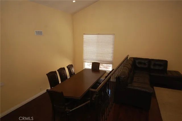a view of a living room with wooden floor