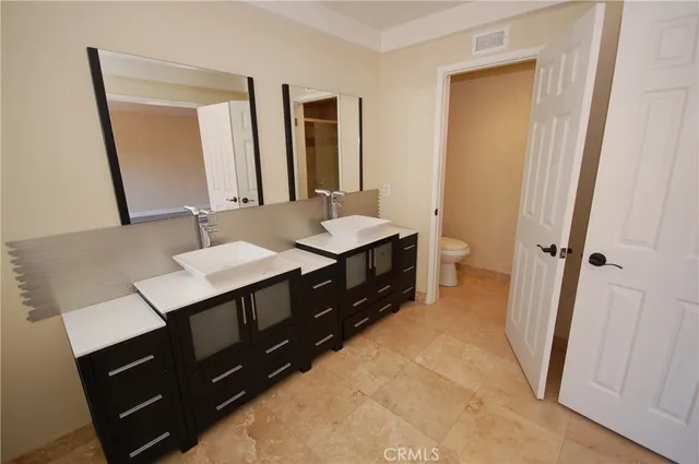 a view of a sink a microwave a stove and refrigerator in a kitchen