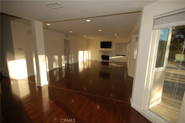 a view of hallway with wooden floor