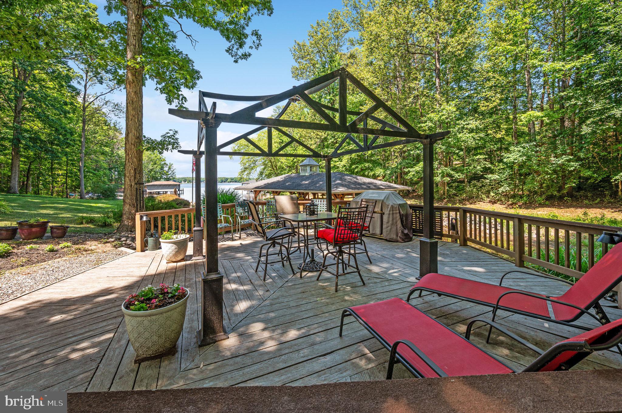 11105 Waddell Road Bumpass, VA 23024 - Photo 13 of 76 a view of a deck with couches table and chairs