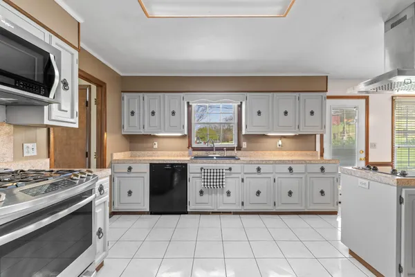 a spacious bathroom with a double vanity sink a mirror and a bathtub