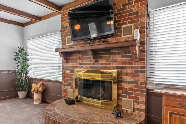 an empty room with closet and a chandelier fan