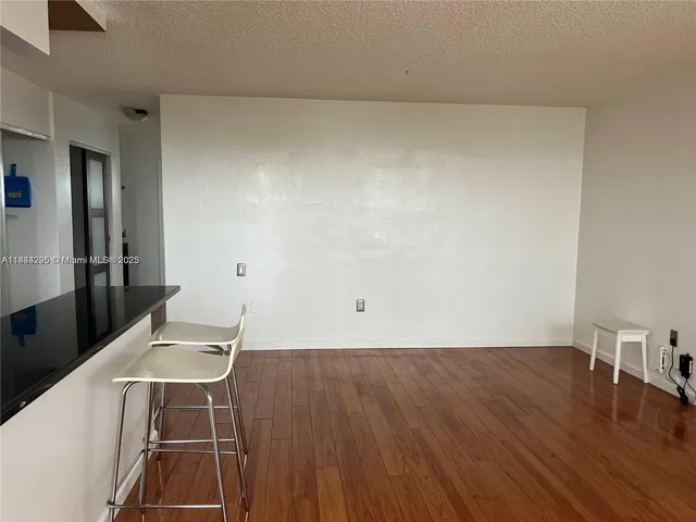 a room with wooden floor and furniture