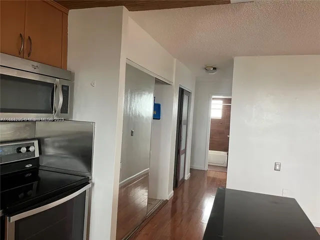 a kitchen with a refrigerator and a sink