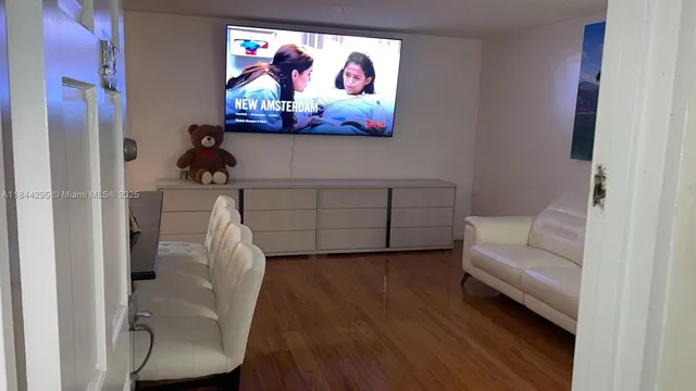 a living room with furniture and a painting on the wall