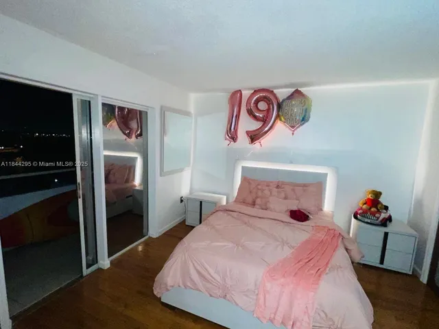 a bedroom with a bed and a potted plant