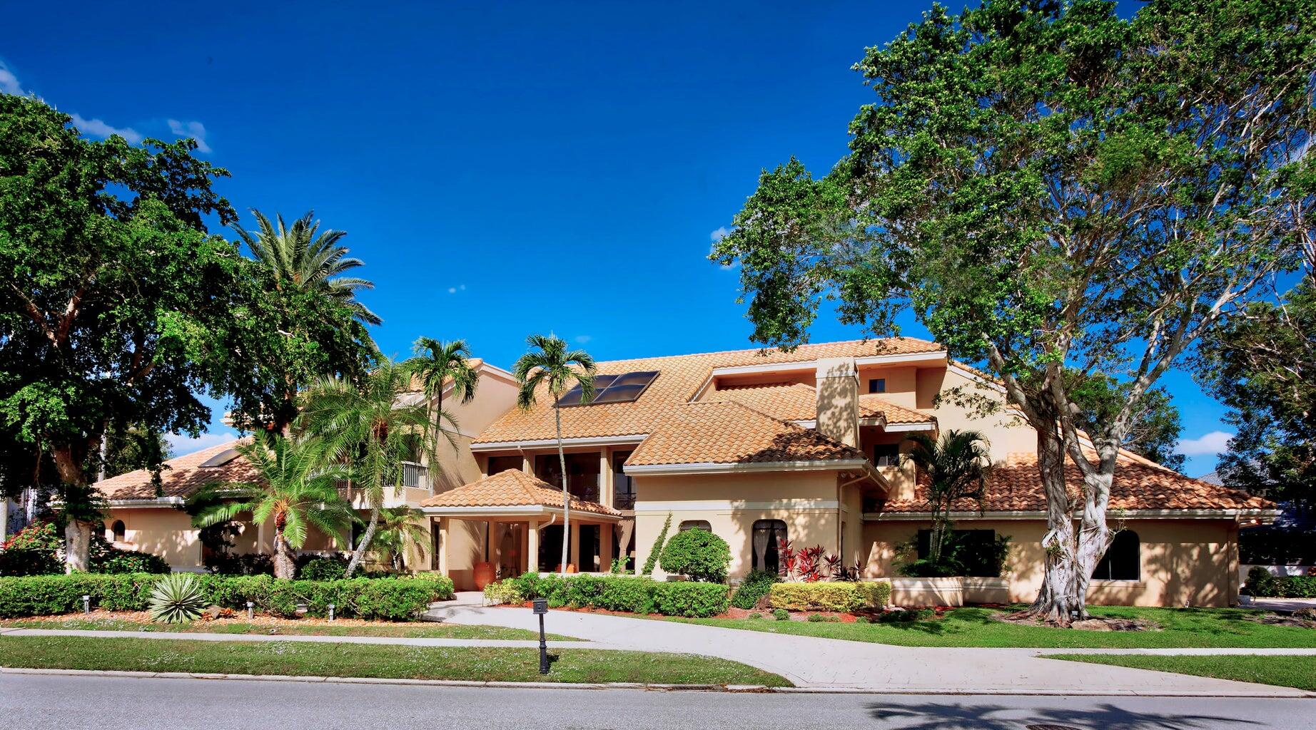 21125 Hamlin Drive Boca Raton, FL 33433 - Photo 1 of 69 a view of a white house next to a yard with big trees