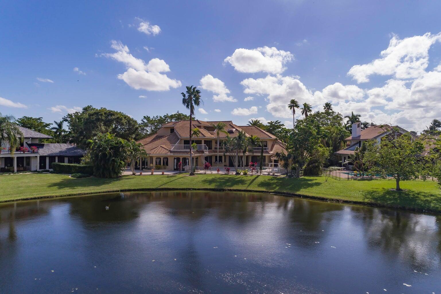 21125 Hamlin Drive Boca Raton, FL 33433 - Photo 42 of 69 a view of a lake with a house in the background