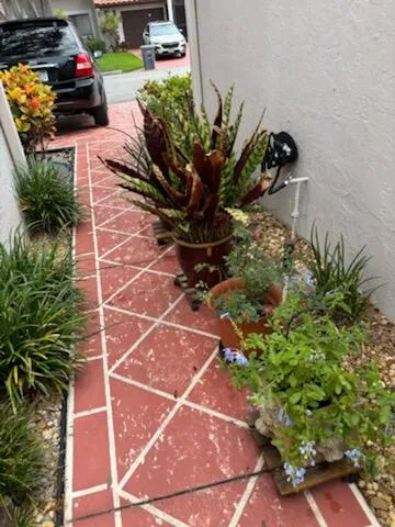 a front view of a house with a garden and a yard
