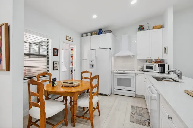 an aerial view of a house with a garden and lake view