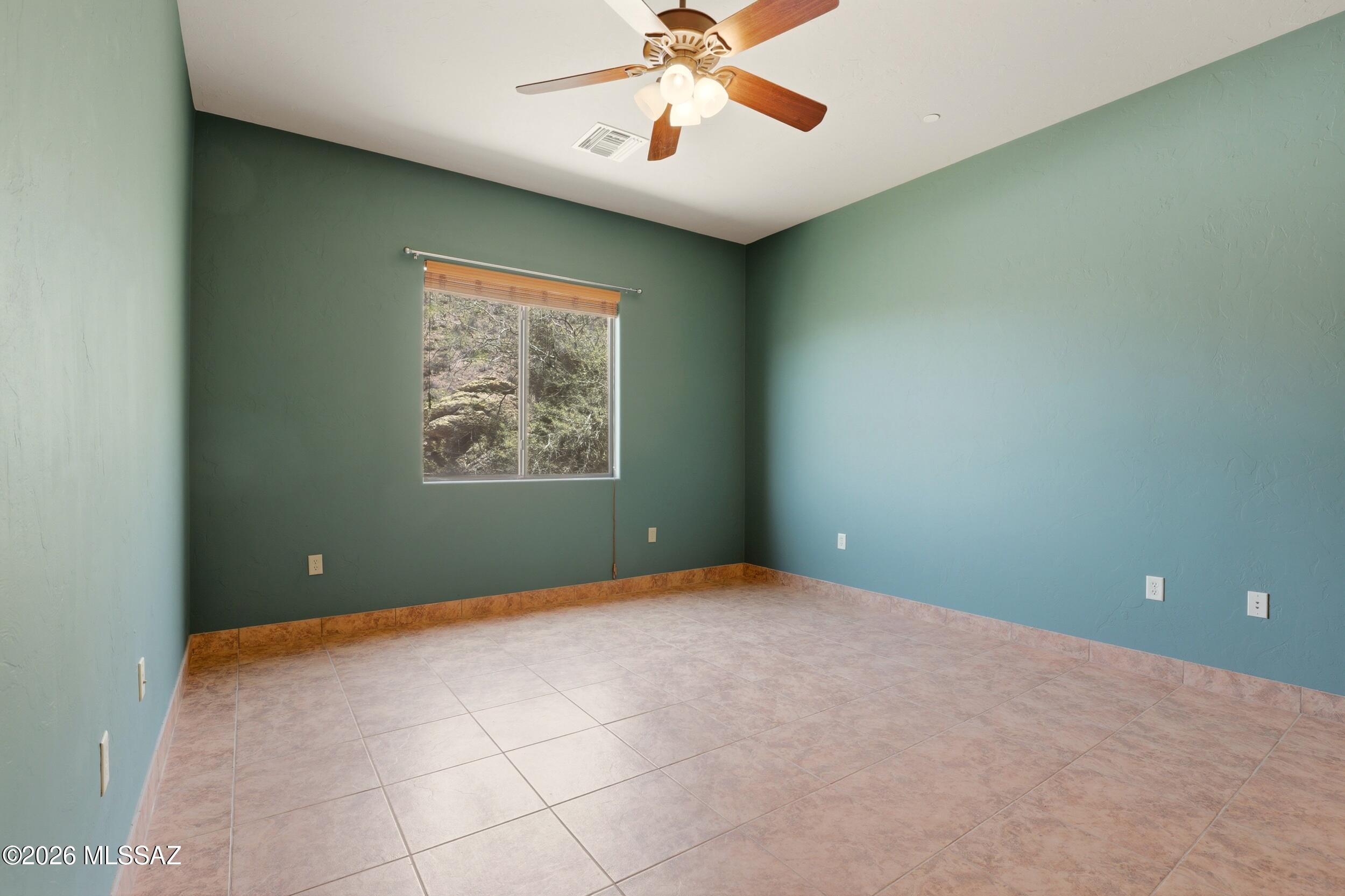 6331 West Trails End Road Tucson, AZ 85745 - Photo 17 of 41 an empty room with windows and fan