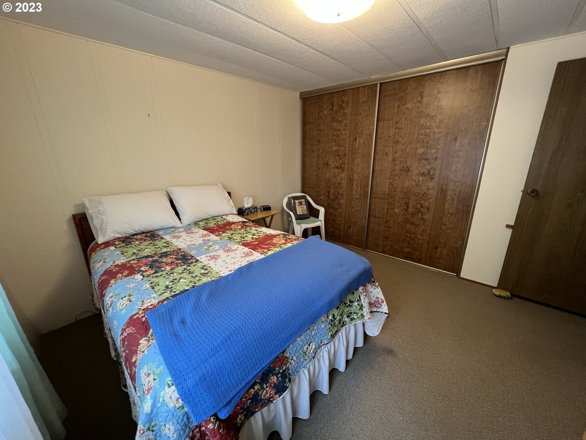 1601 Rhododendron Drive, Unit 586 Florence, OR 97439 - Photo 18 of 22 a bedroom with a bed and a mirror