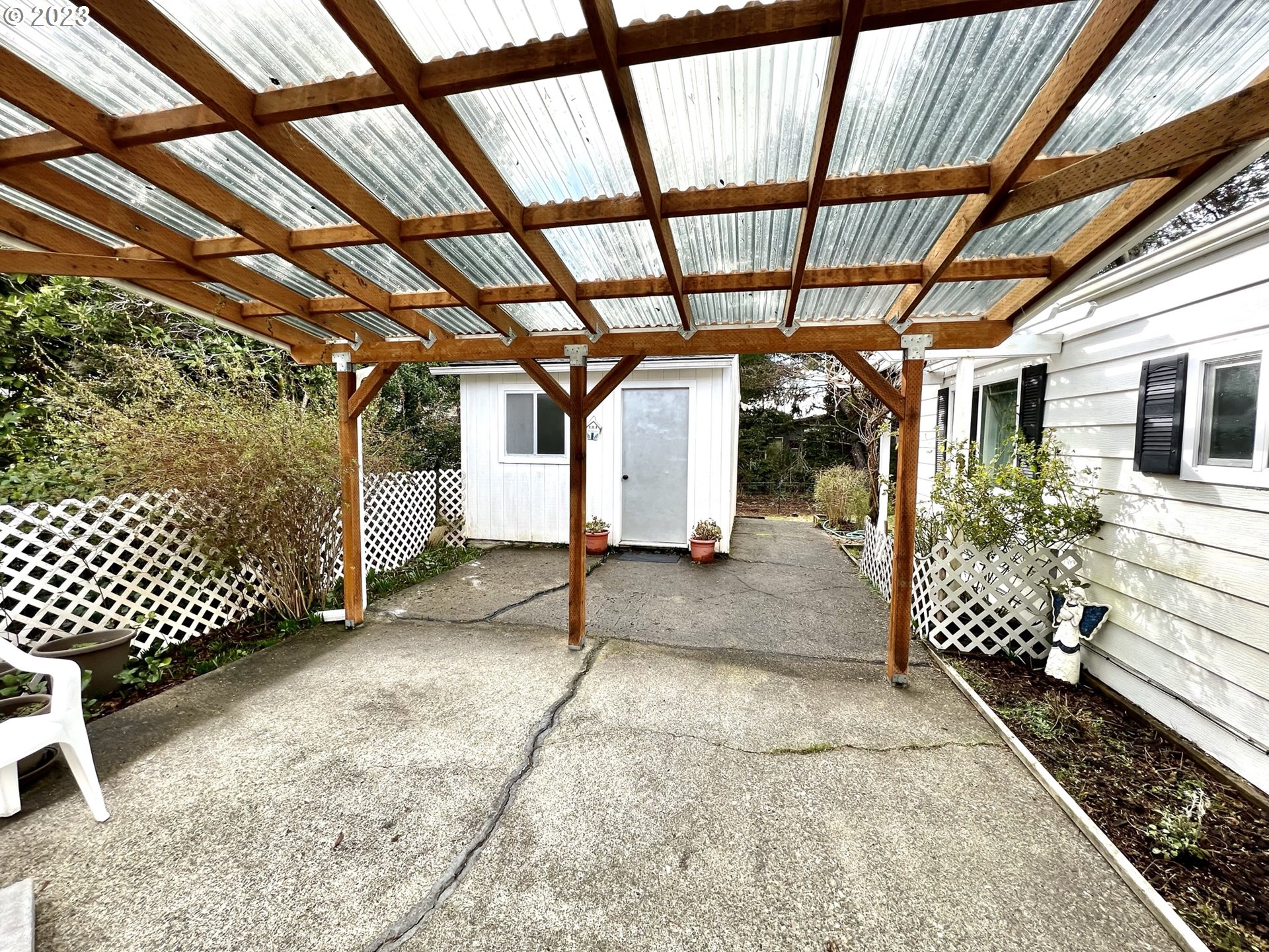 1601 Rhododendron Drive, Unit 586 Florence, OR 97439 - Photo 19 of 22 a view of a porch with a bench