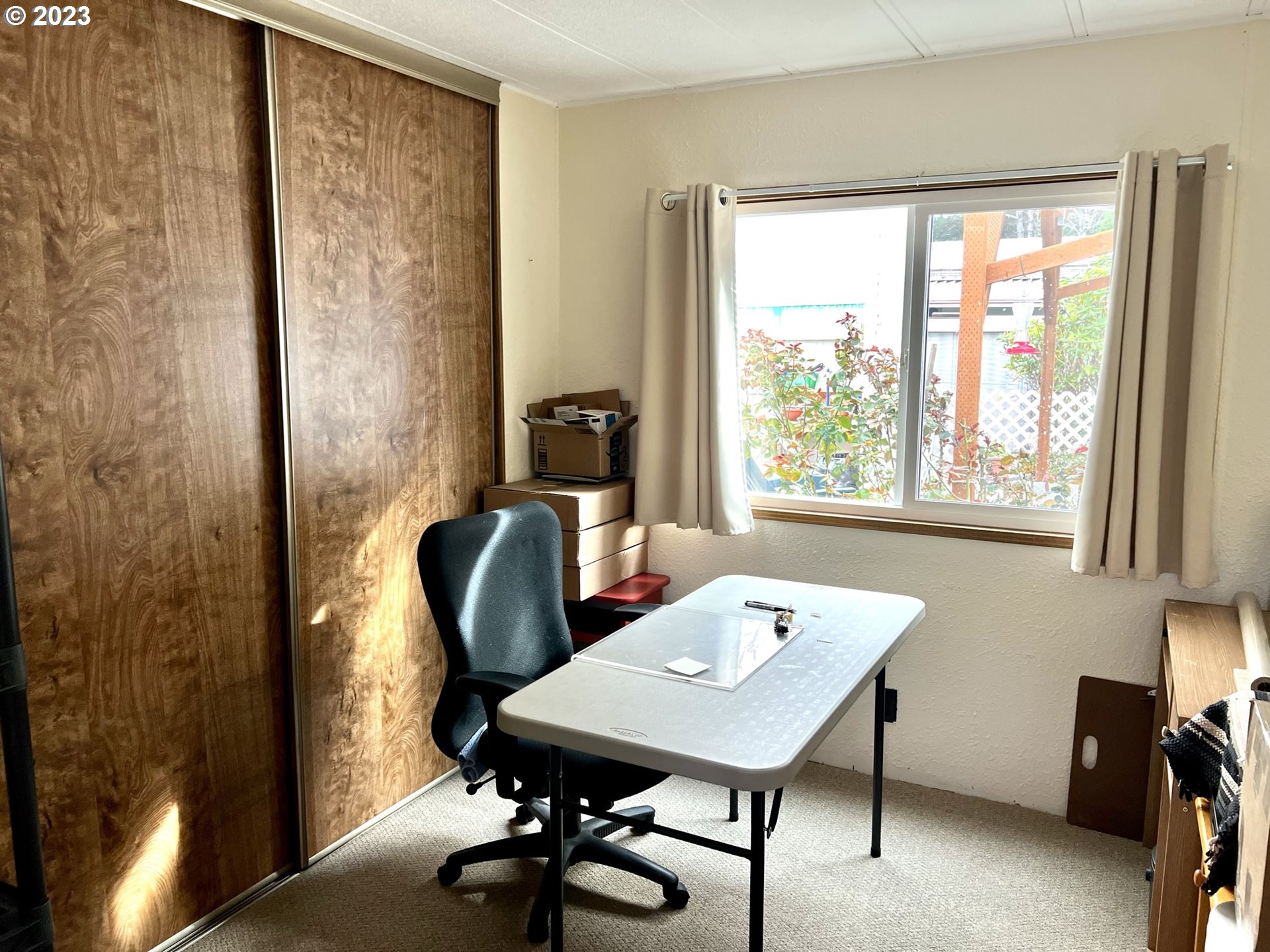 1601 Rhododendron Drive, Unit 586 Florence, OR 97439 - Photo 9 of 22 a view of a workspace with furniture and a window