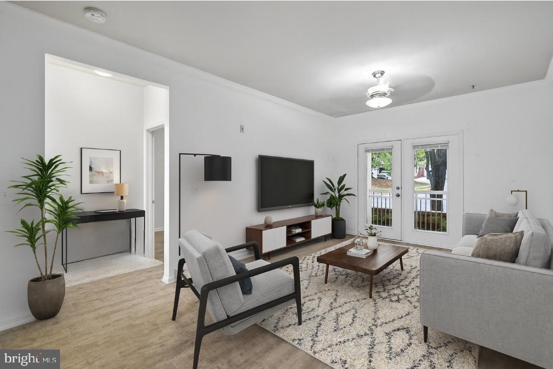 9490 Virginia Center Boulevard, Unit 127 Vienna, VA 22181 - Photo 11 of 31 a living room with furniture and a flat screen tv
