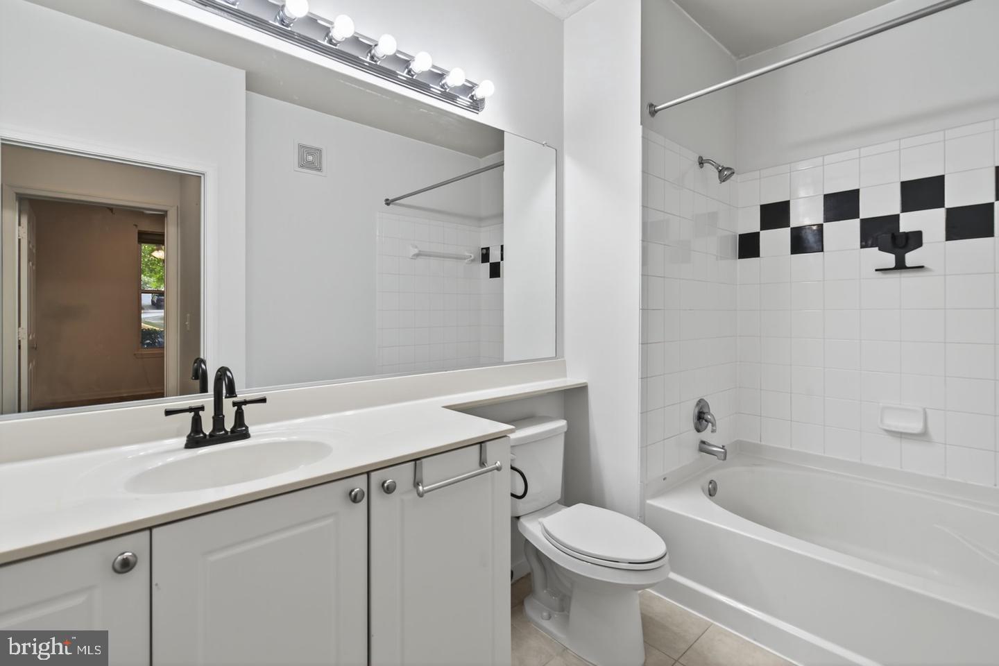 9490 Virginia Center Boulevard, Unit 127 Vienna, VA 22181 - Photo 13 of 31 a bathroom with a sink a toilet a mirror and shower
